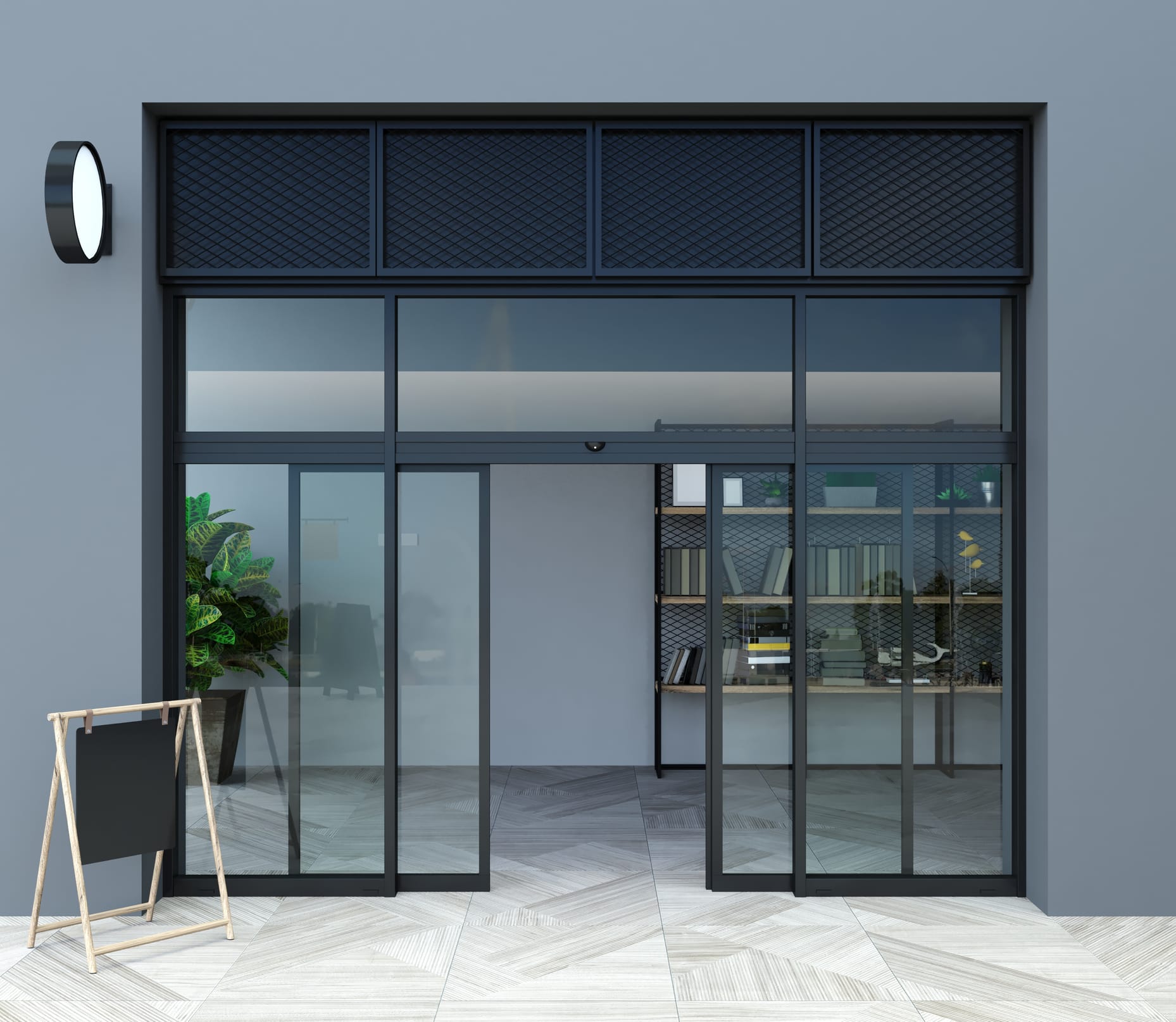 Contemporary office entryway with black-framed automatic glass doors, showcasing an interior with bookshelves and a minimalist workspace behind clear panels.