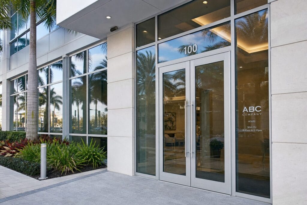 Impact-rated commercial storefront entrance with glass doors on South Florida office building